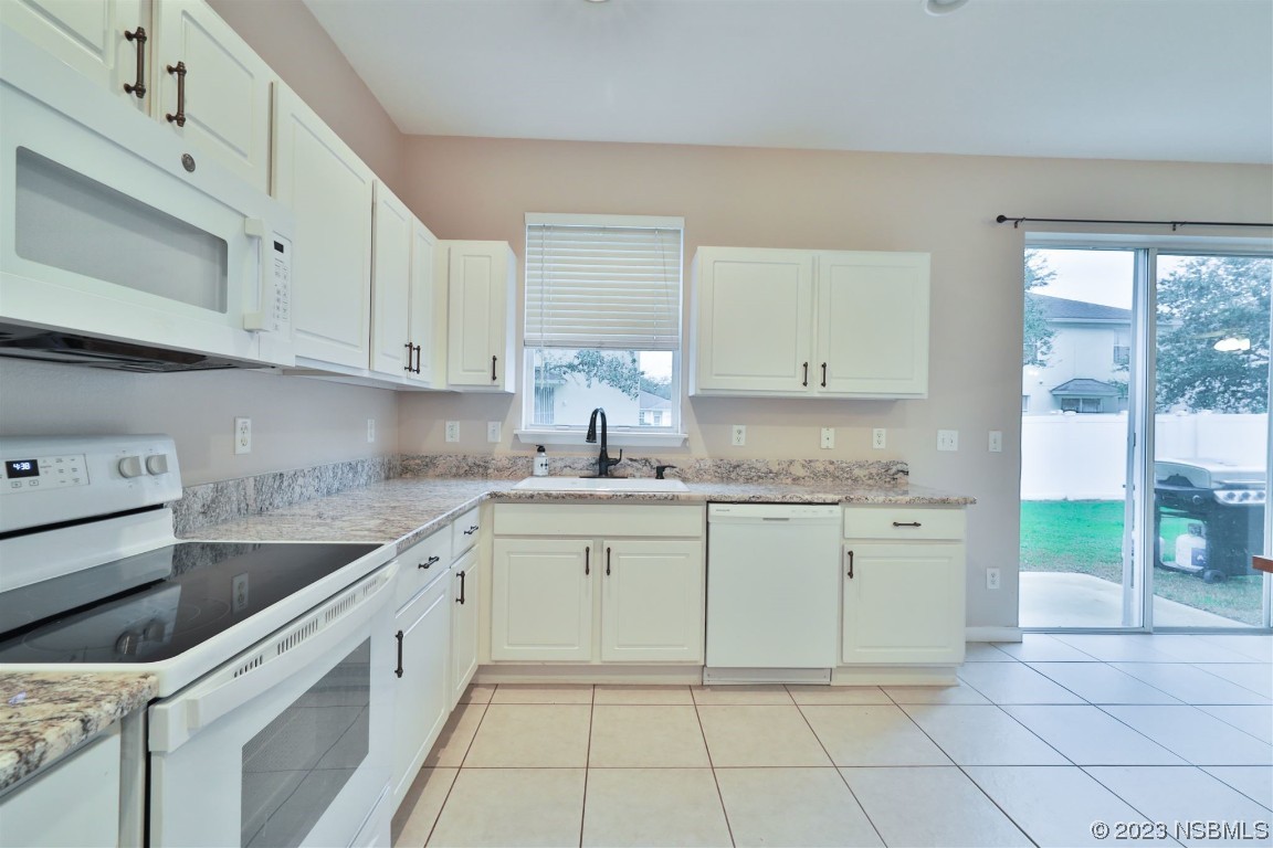 1922 Cove Point Road Port Orange, FL 32128 - Photo 14 of 54 a kitchen with a sink and cabinets