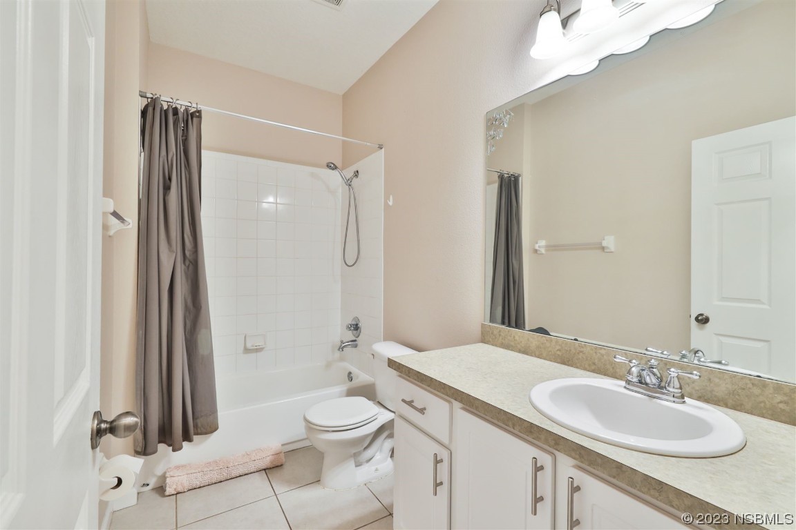 1922 Cove Point Road Port Orange, FL 32128 - Photo 16 of 54 a bathroom with a granite countertop sink toilet a mirror and shower