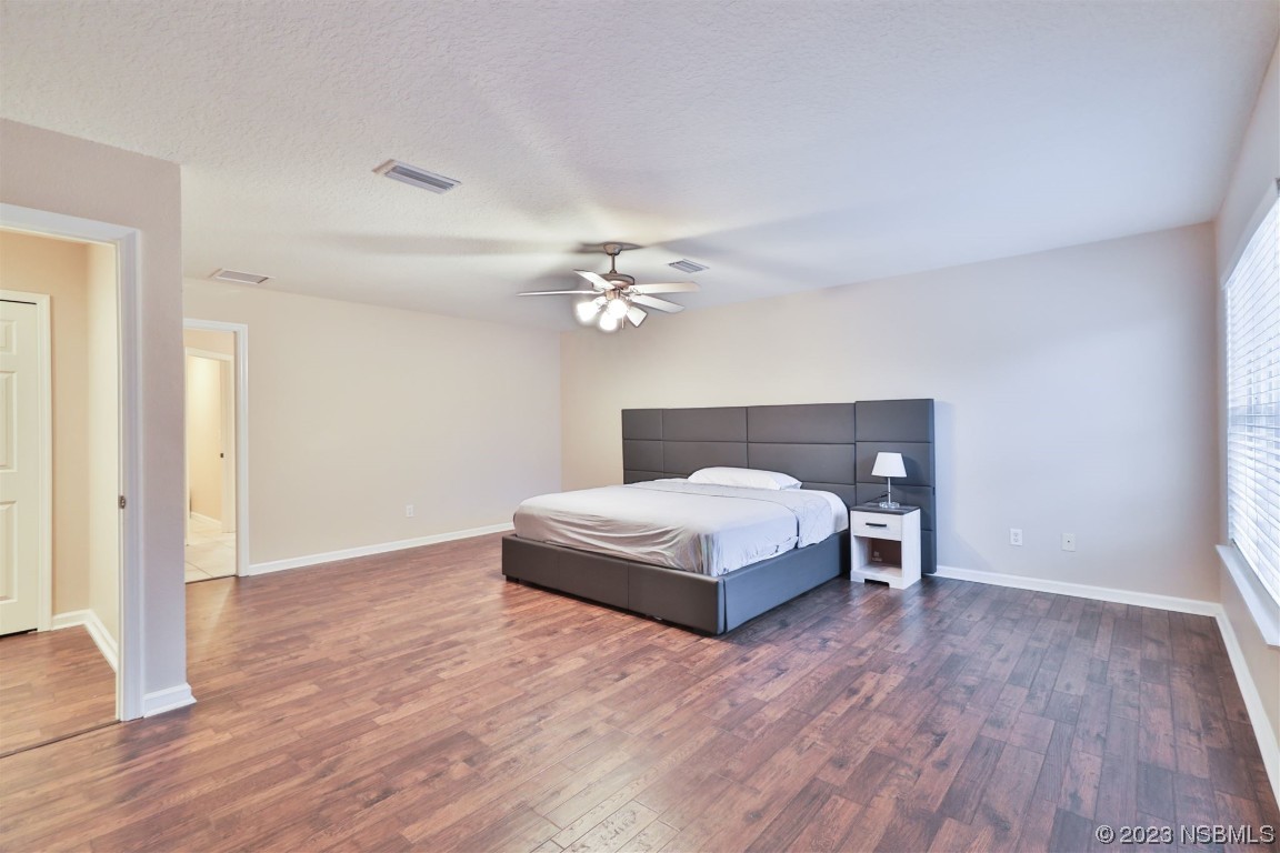 1922 Cove Point Road Port Orange, FL 32128 - Photo 19 of 54 a bedroom with a bed and wooden floor