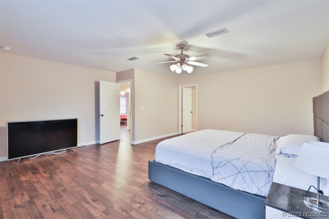 1922 Cove Point Road Port Orange, FL 32128 - Photo 20 of 54 a bedroom with a bed and a chandelier