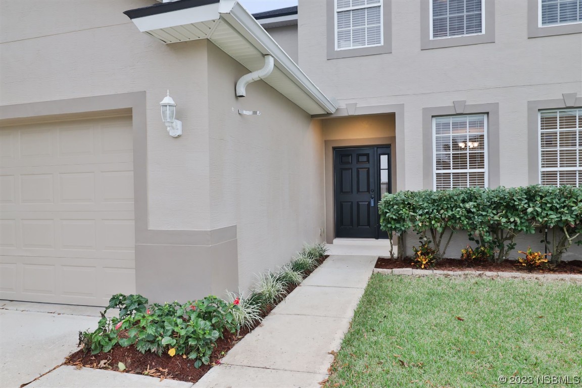 1922 Cove Point Road Port Orange, FL 32128 - Photo 2 of 54 a front view of a house with a yard