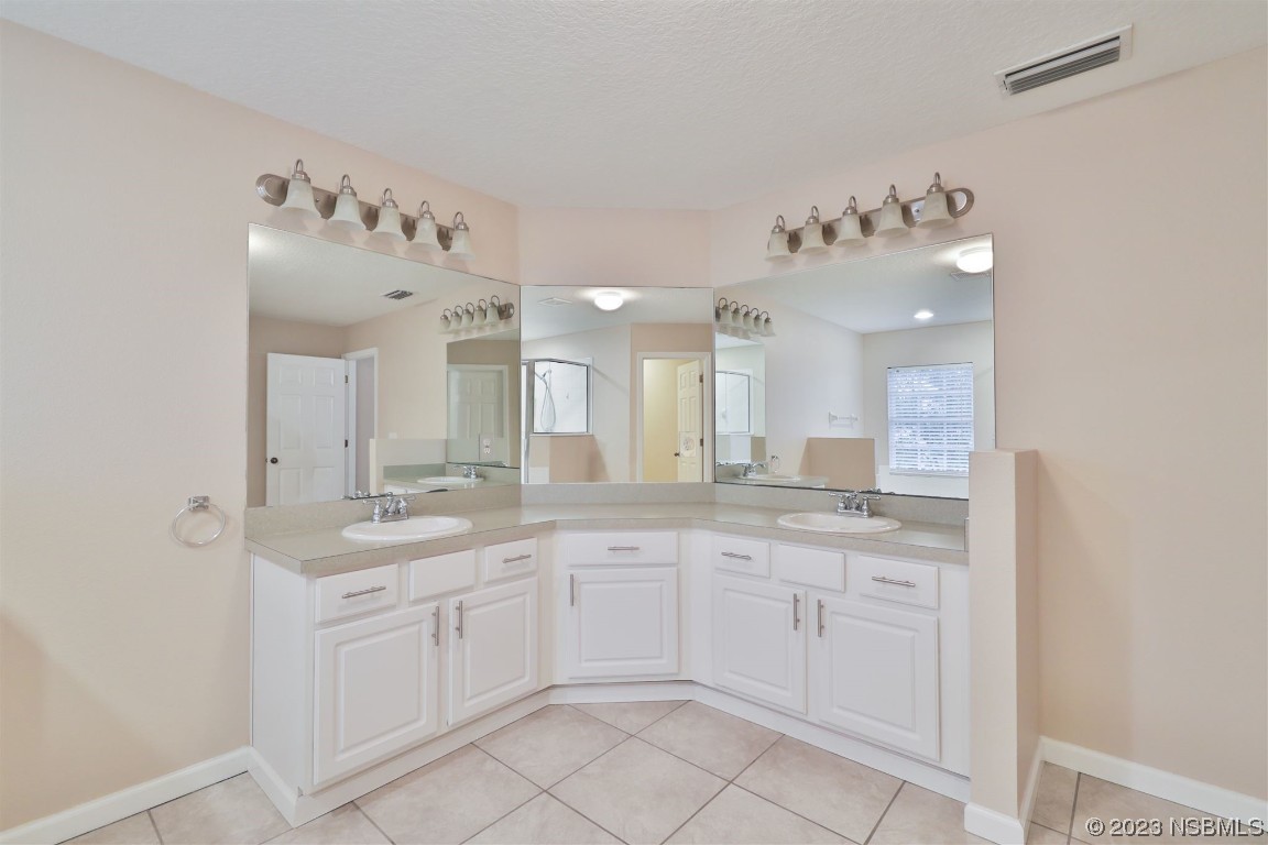 1922 Cove Point Road Port Orange, FL 32128 - Photo 22 of 54 a spacious bathroom with a granite countertop sink a mirror and a bathtub