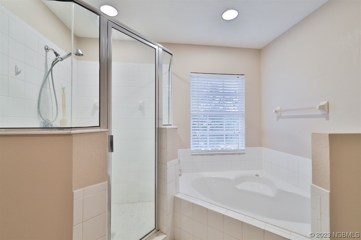 1922 Cove Point Road Port Orange, FL 32128 - Photo 23 of 54 a bathroom with a bathtub and a shower
