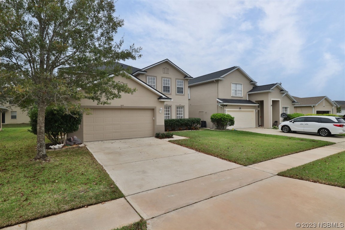1922 Cove Point Road Port Orange, FL 32128 - Photo 33 of 54 a front view of a house with a yard and garage