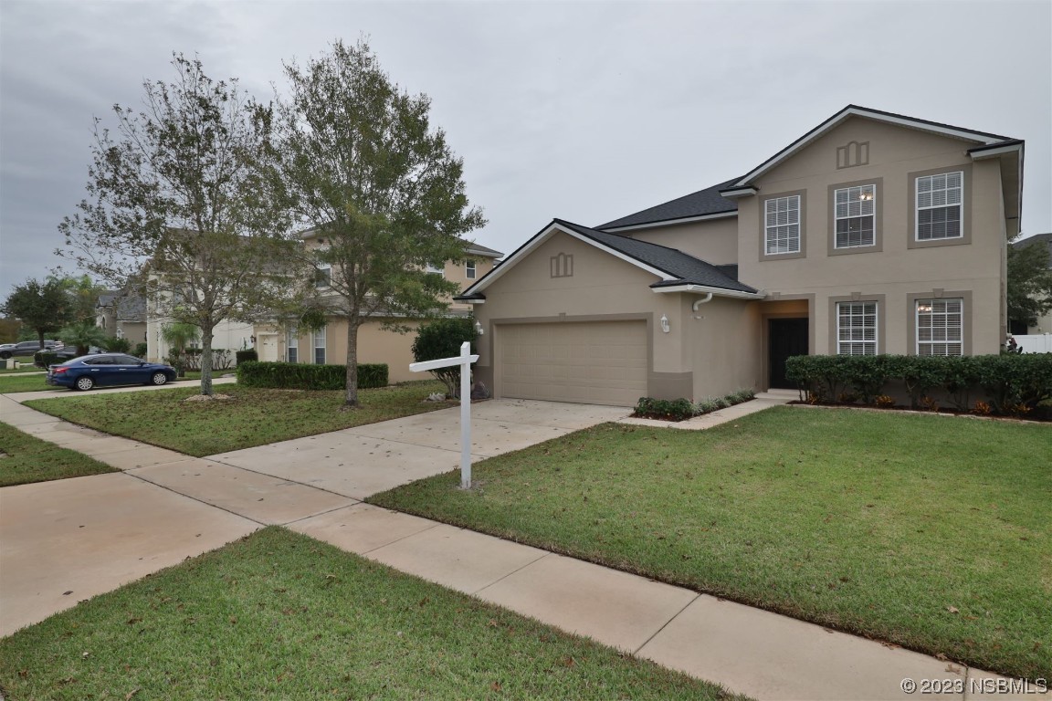 1922 Cove Point Road Port Orange, FL 32128 - Photo 37 of 54 a view of a big house with a big yard and large trees