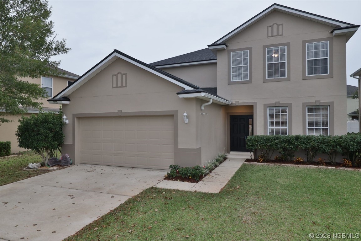 1922 Cove Point Road Port Orange, FL 32128 - Photo 38 of 54 a front view of a house with a yard and garage