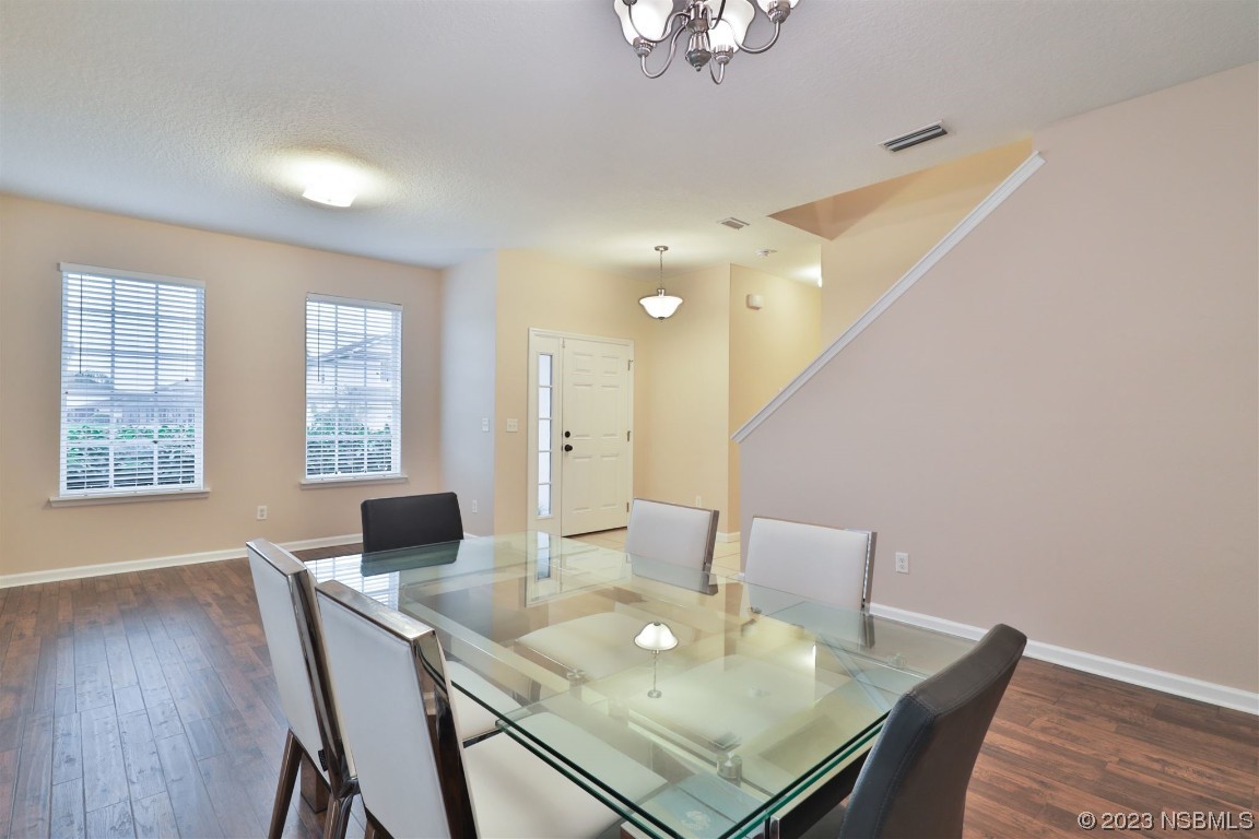 1922 Cove Point Road Port Orange, FL 32128 - Photo 5 of 54 a view of a dining room with furniture and wooden floor