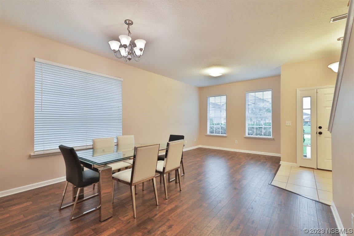 1922 Cove Point Road Port Orange, FL 32128 - Photo 6 of 54 a view of a dining room with furniture and wooden floor