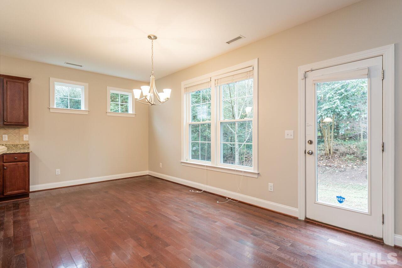 524 Bouree Circle Raleigh, NC 27606 - Photo 11 of 34 a view of an empty room with a window and wooden floor