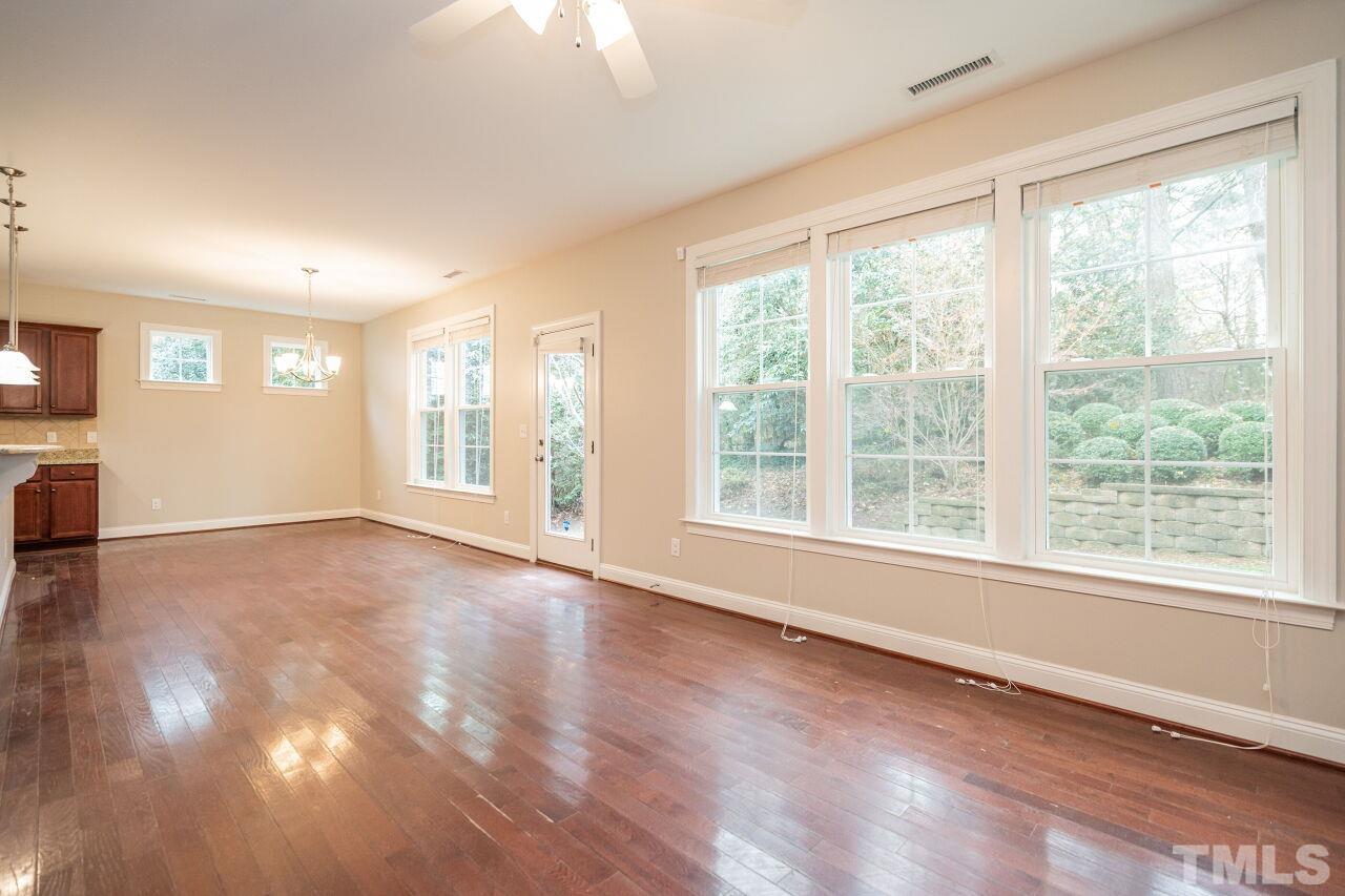 524 Bouree Circle Raleigh, NC 27606 - Photo 10 of 34 a view of an empty room with a window and wooden floor