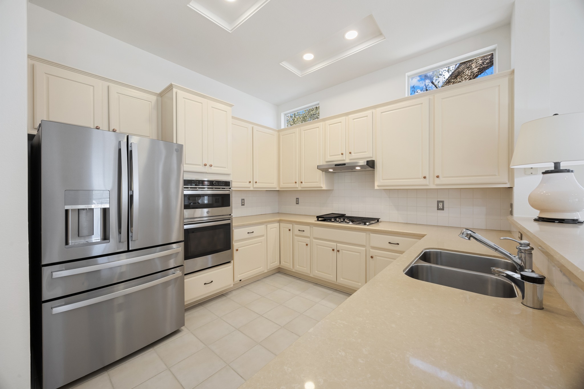 170 Dan Moody Trail Georgetown, TX 78633 - Photo 10 of 30 a kitchen with granite countertop white cabinets and stainless steel appliances