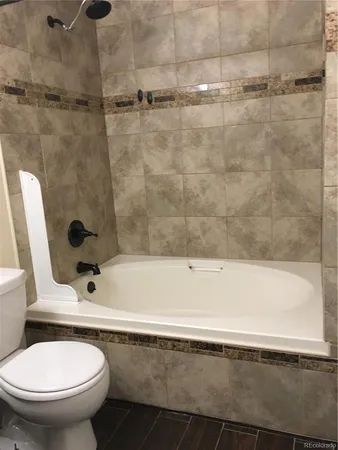 a bathroom with a bathtub and a toilet