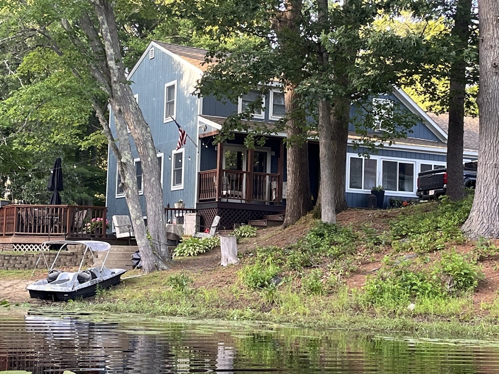 a view of a house with pool and chairs