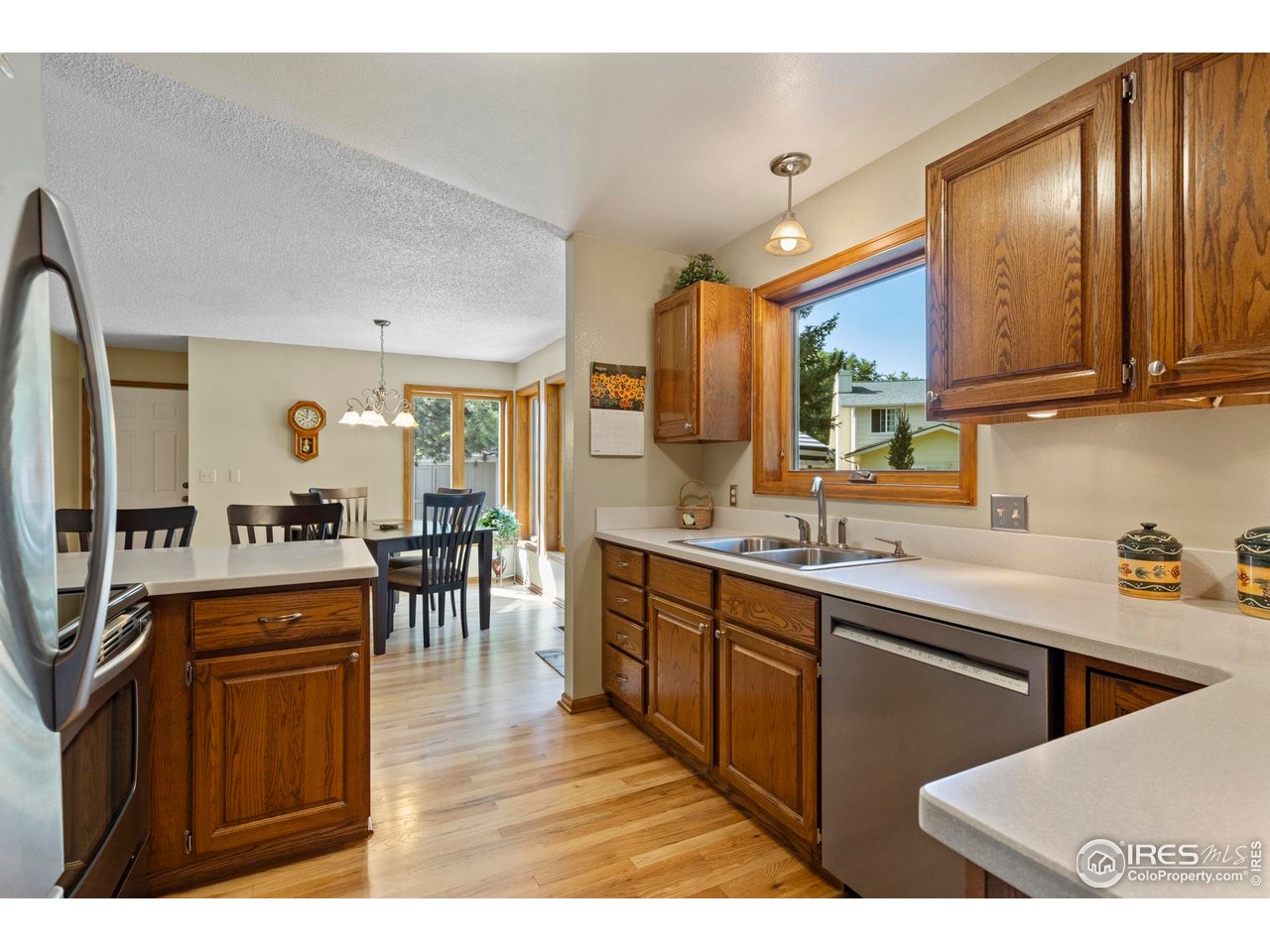 The kitchen includes stainless steel appliances.