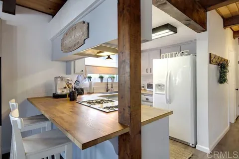 a kitchen with stainless steel appliances granite countertop a sink refrigerator and microwave