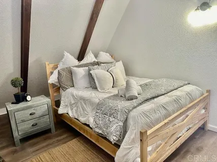 a bedroom with a bed and a tv