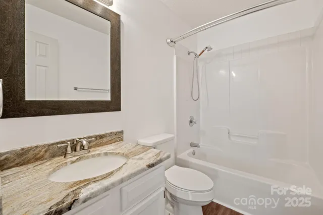 a view of a livingroom with furniture hardwood floor and staircase