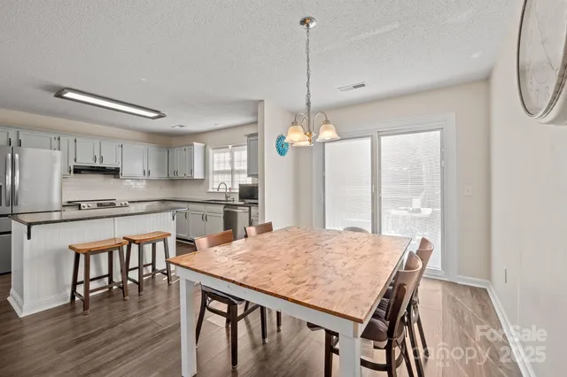 a kitchen with stainless steel appliances granite countertop a stove refrigerator sink and cabinets