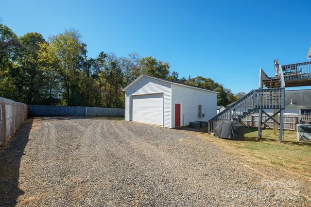 a view of house with garage and yard