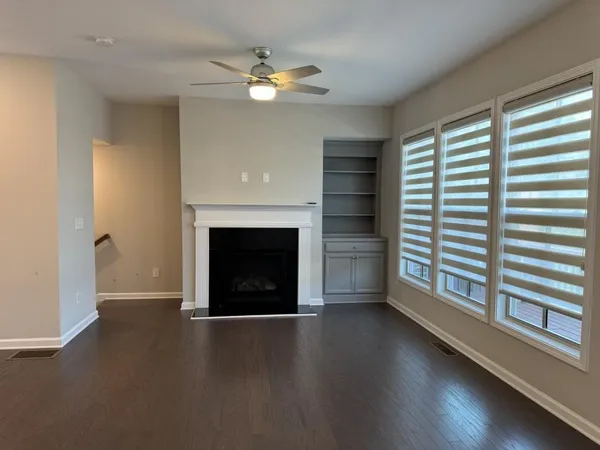 a view of staircase with railing and a window