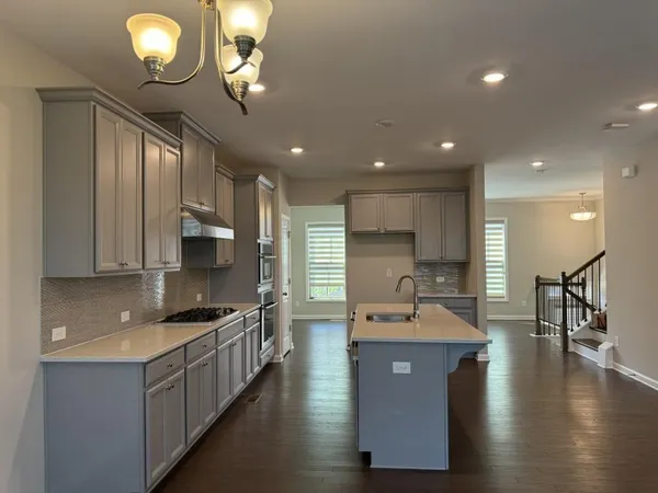 a close view of a stove a microwave and cabinets