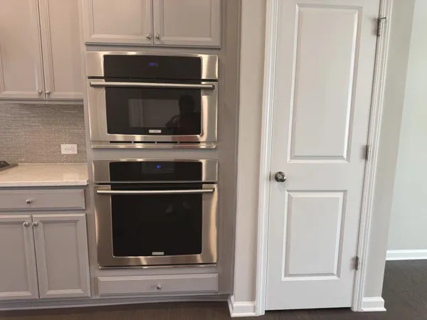 a kitchen with a sink a microwave and cabinets