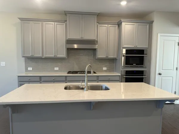 a view of a kitchen with wooden floor and cabinets