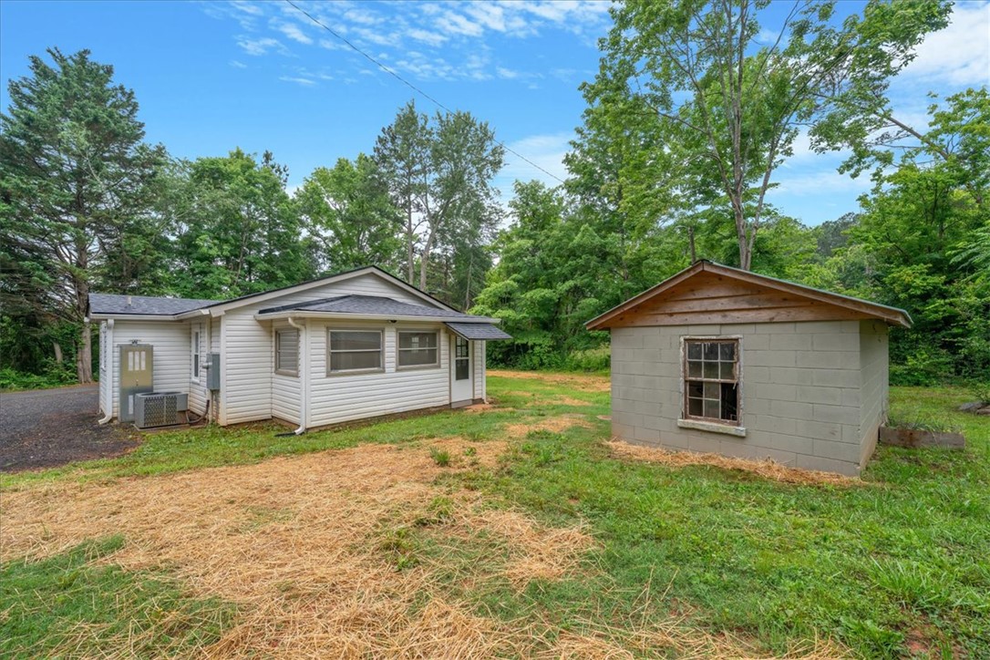 174 Holliday Road Six Mile, SC 29682 - Photo 37 of 49 A quaint residence with a separate shed sits amidst lush greenery