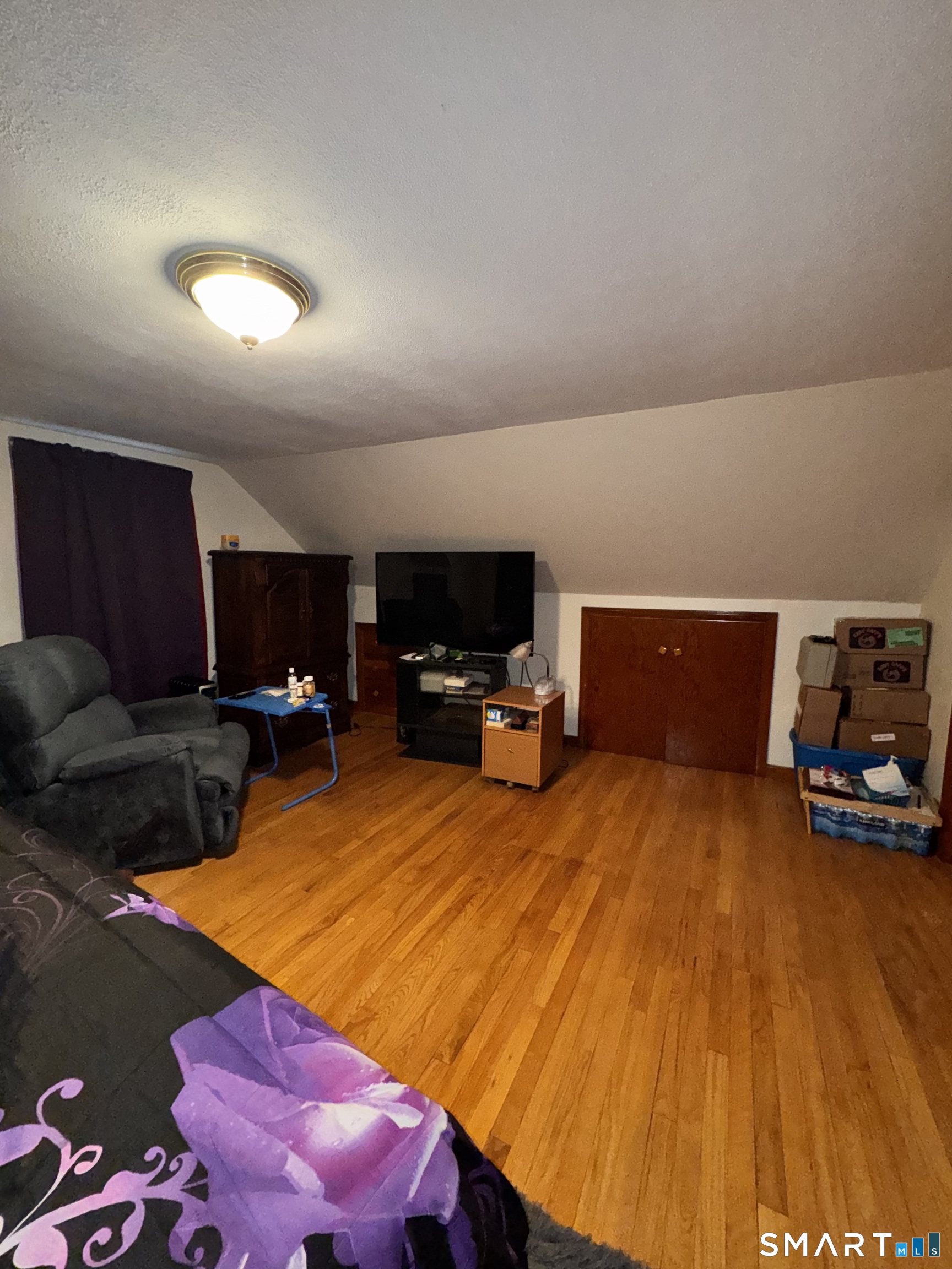 45 Lawrence Street Vernon, CT 06066 - Photo 11 of 17 a room with furniture and a wooden floor