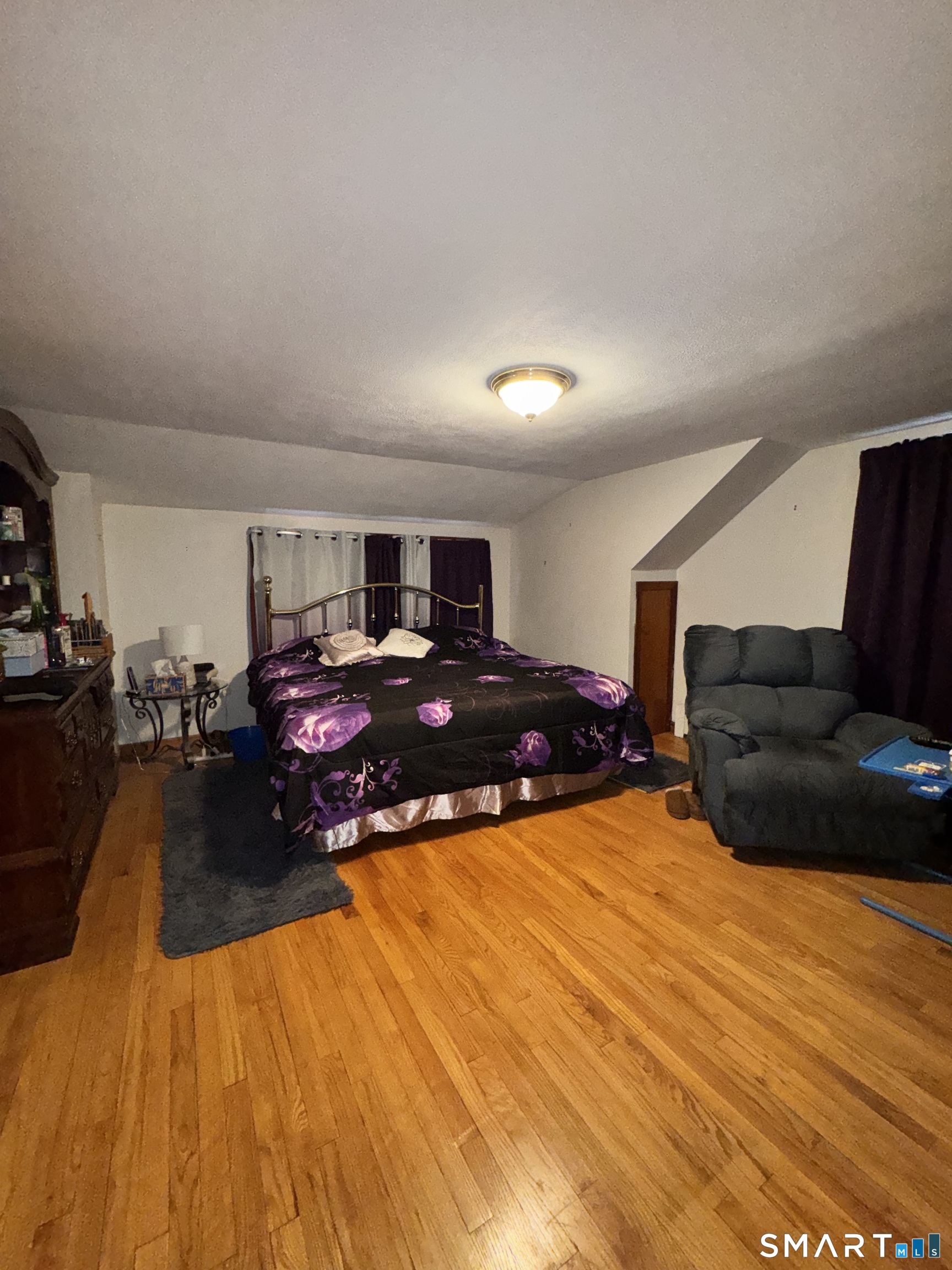 45 Lawrence Street Vernon, CT 06066 - Photo 10 of 17 a living room with furniture and a wooden floor