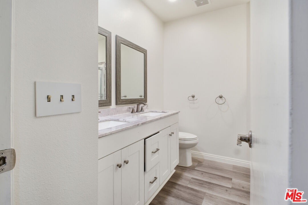 622 West Regent Street, Unit 5 Inglewood, CA 90301 - Photo 11 of 16 a bathroom with a double vanity sink toilet and a mirror