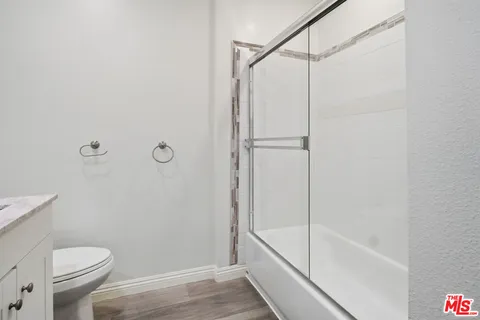 a bathroom with a shower and a toilet