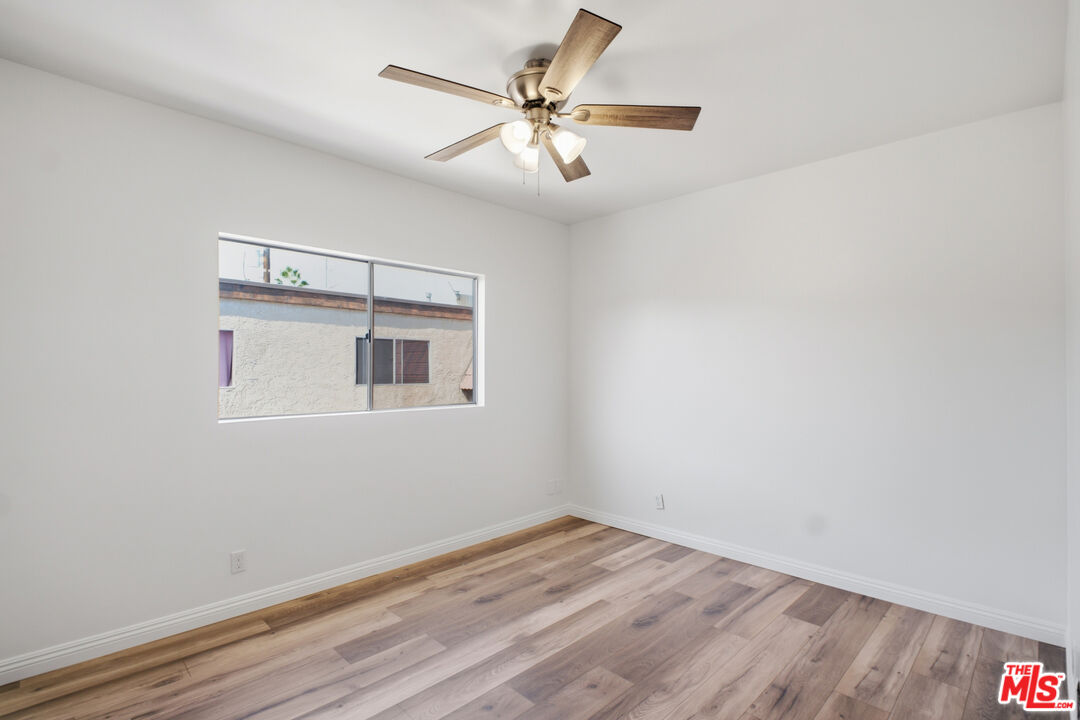 622 West Regent Street, Unit 5 Inglewood, CA 90301 - Photo 14 of 16 a view of a room with wooden floor and a ceiling fan