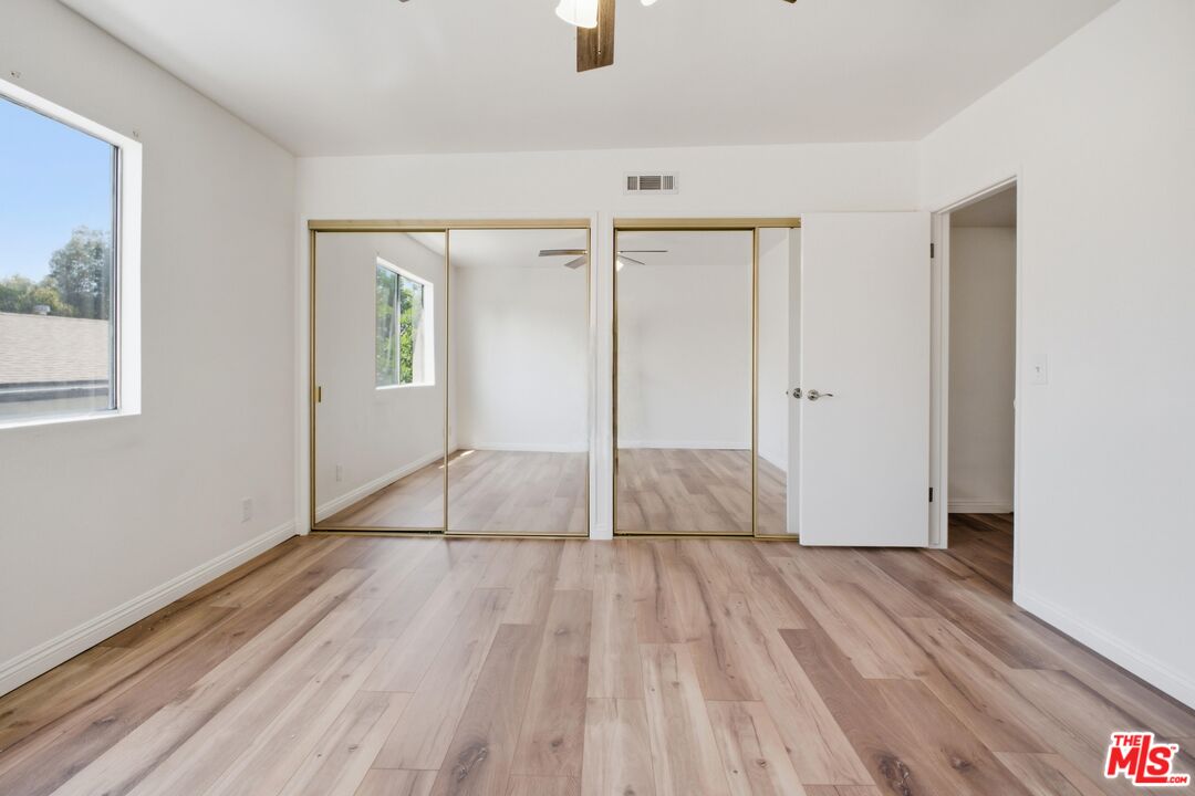 622 West Regent Street, Unit 5 Inglewood, CA 90301 - Photo 15 of 16 a view of empty room with wooden floor and fan