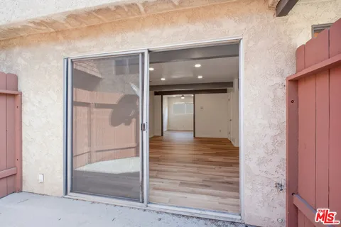 a view of a hallway view with wooden floor and staircase