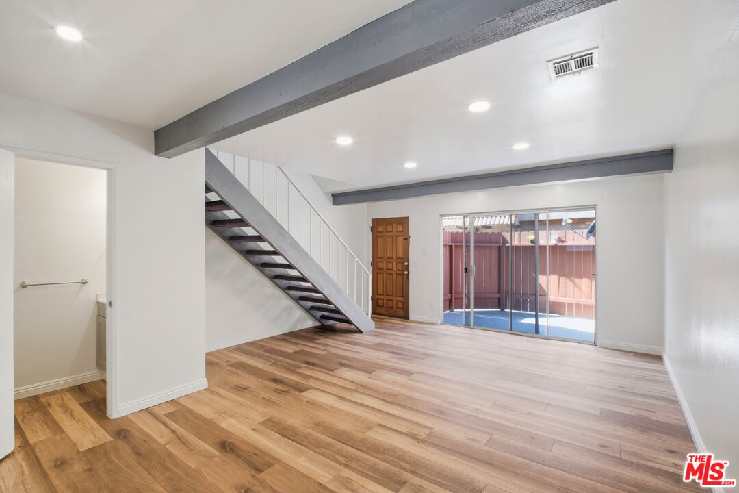 622 West Regent Street, Unit 5 Inglewood, CA 90301 - Photo 2 of 16 a view of an empty room with wooden floor and stairs