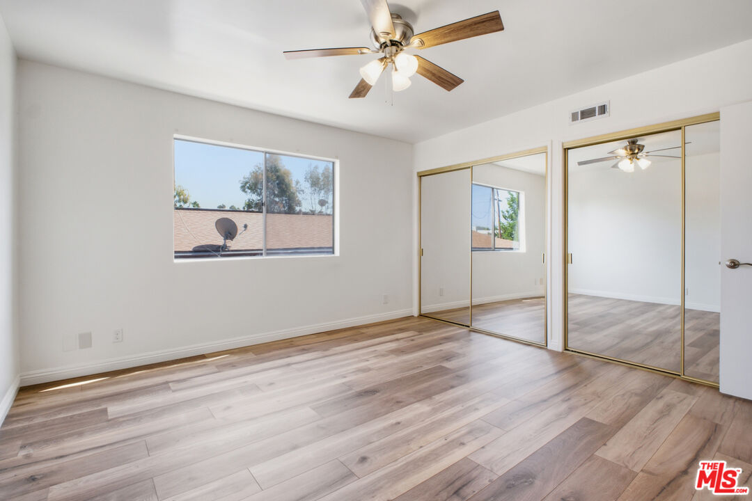 622 West Regent Street, Unit 5 Inglewood, CA 90301 - Photo 8 of 16 wooden floor in an empty room with a window