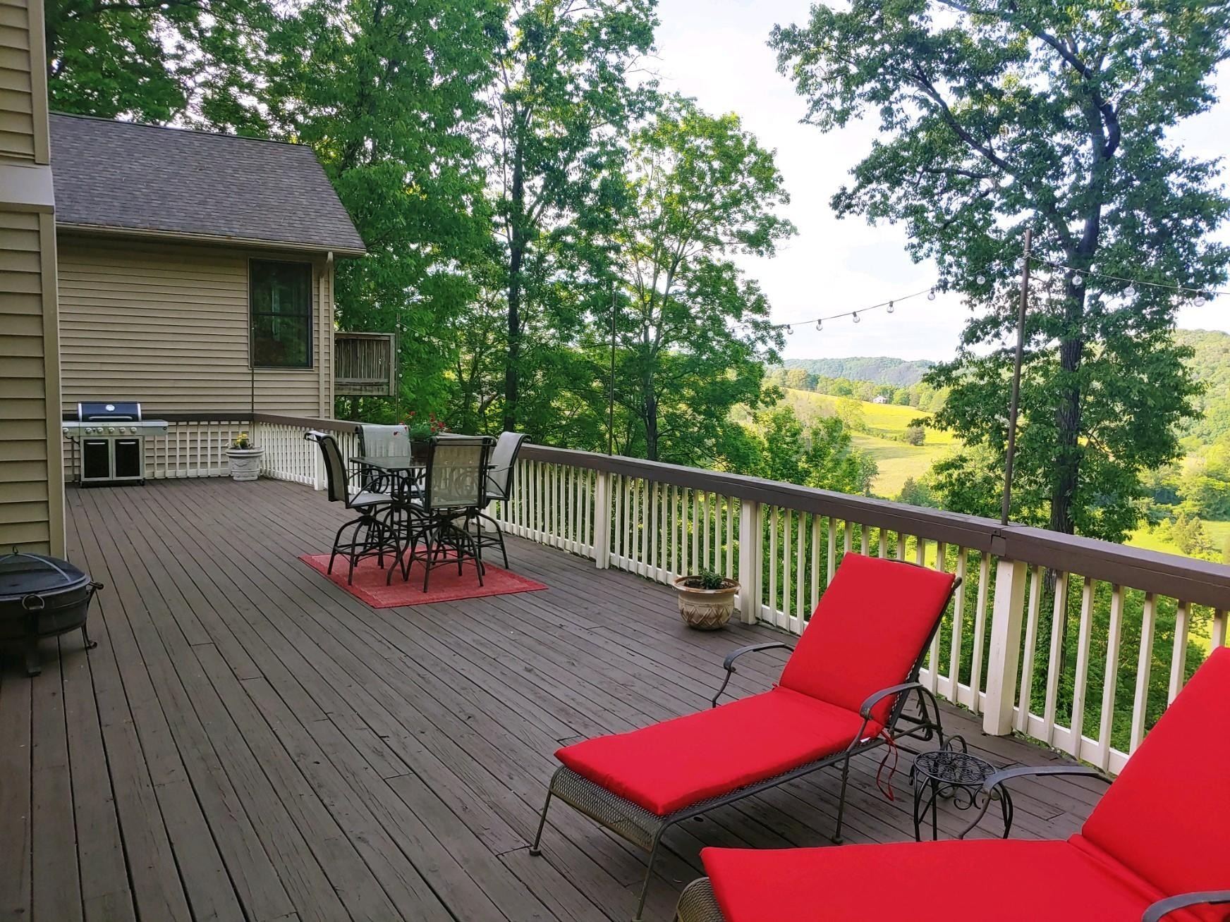 456 Lewallen Road Clinton, TN 37716 - Photo 5 of 26 a balcony with wooden floor table and chairs