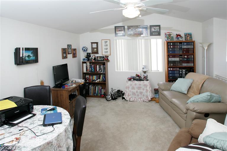 2005 Tulip Avenue Simi Valley, CA 93063 - Photo 9 of 14 a living room with furniture a flat screen tv and a bookshelf