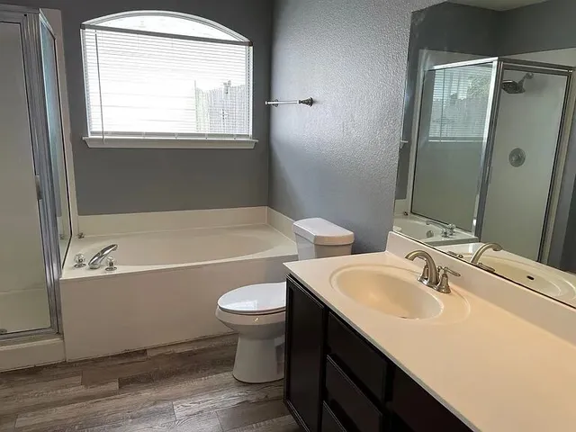 a bathroom with a sink mirror toilet and bathtub
