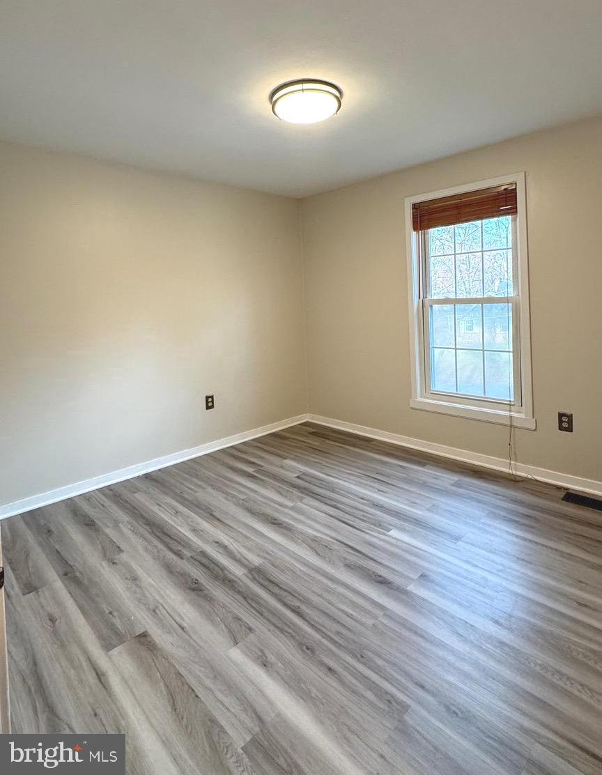 18817 Kerill Road Triangle, VA 22172 - Photo 13 of 23 an empty room with wooden floor and windows