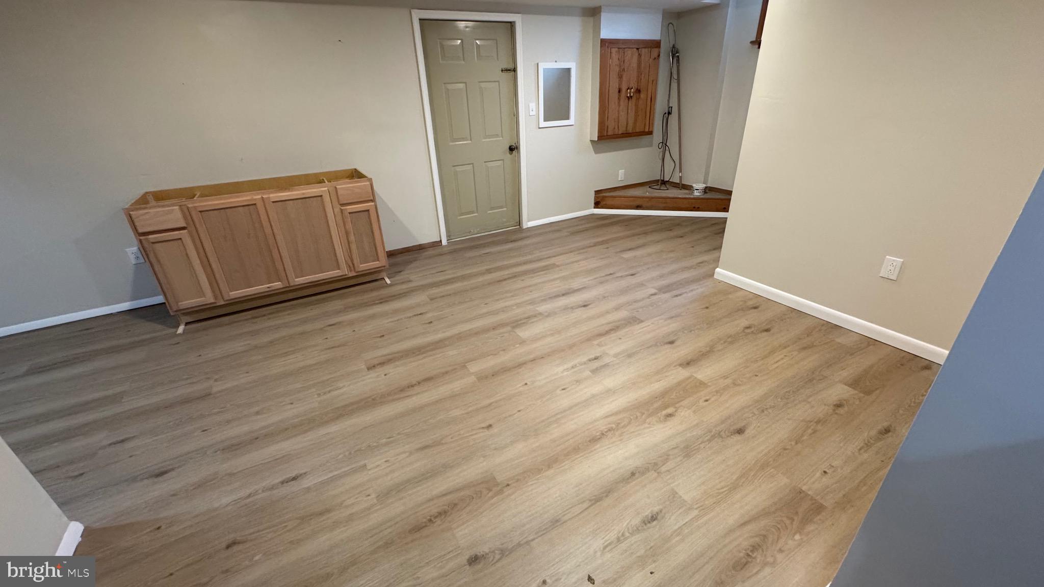 18817 Kerill Road Triangle, VA 22172 - Photo 19 of 23 a view of an empty room with wooden floor and a window