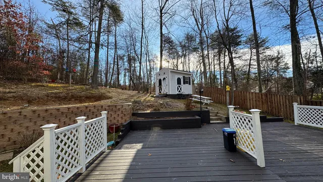 a view of a wooden deck with chairs