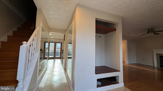 a view of hallway with stairs and wooden floor