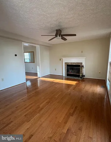 wooden floor in an empty room with a fireplace