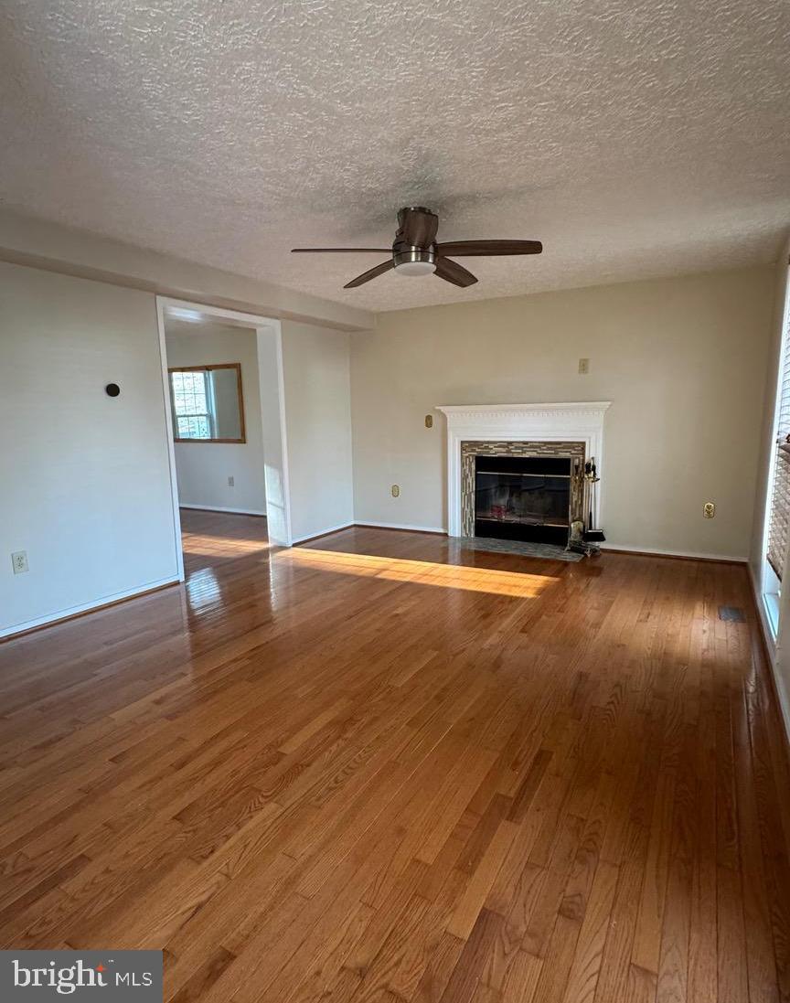 18817 Kerill Road Triangle, VA 22172 - Photo 4 of 23 wooden floor in an empty room with a fireplace