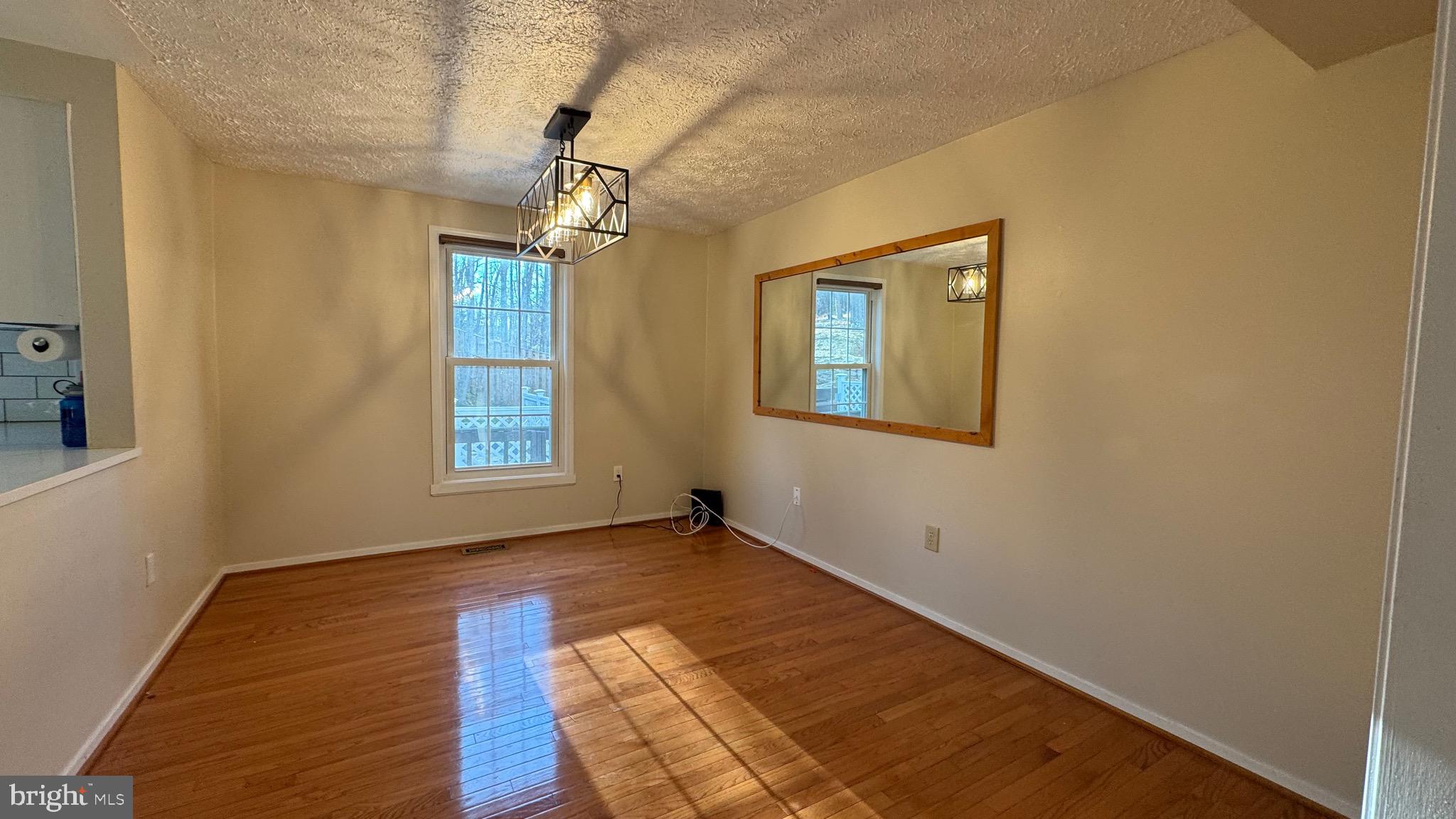 18817 Kerill Road Triangle, VA 22172 - Photo 5 of 23 a view of empty room with wooden floor and fan
