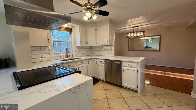 a kitchen with a sink cabinets and window