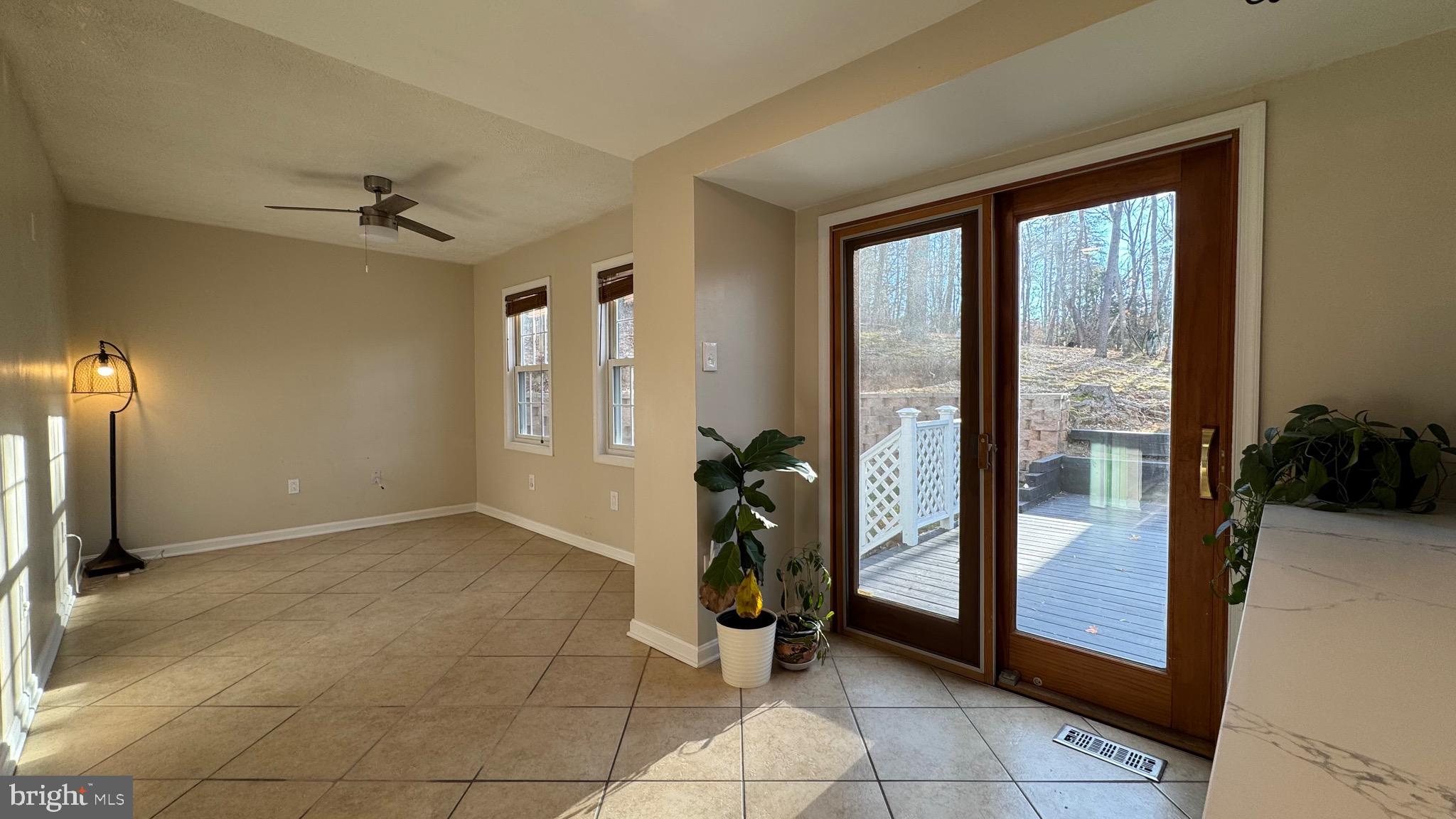 18817 Kerill Road Triangle, VA 22172 - Photo 7 of 23 a living room with a bath tub and glass windows