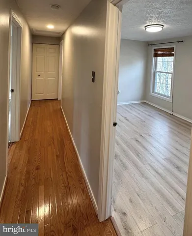 a view of hallway with wooden floor
